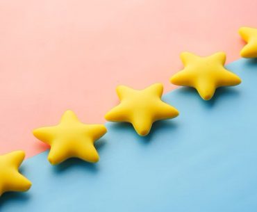 Picture showing five stars on a pink and blue background